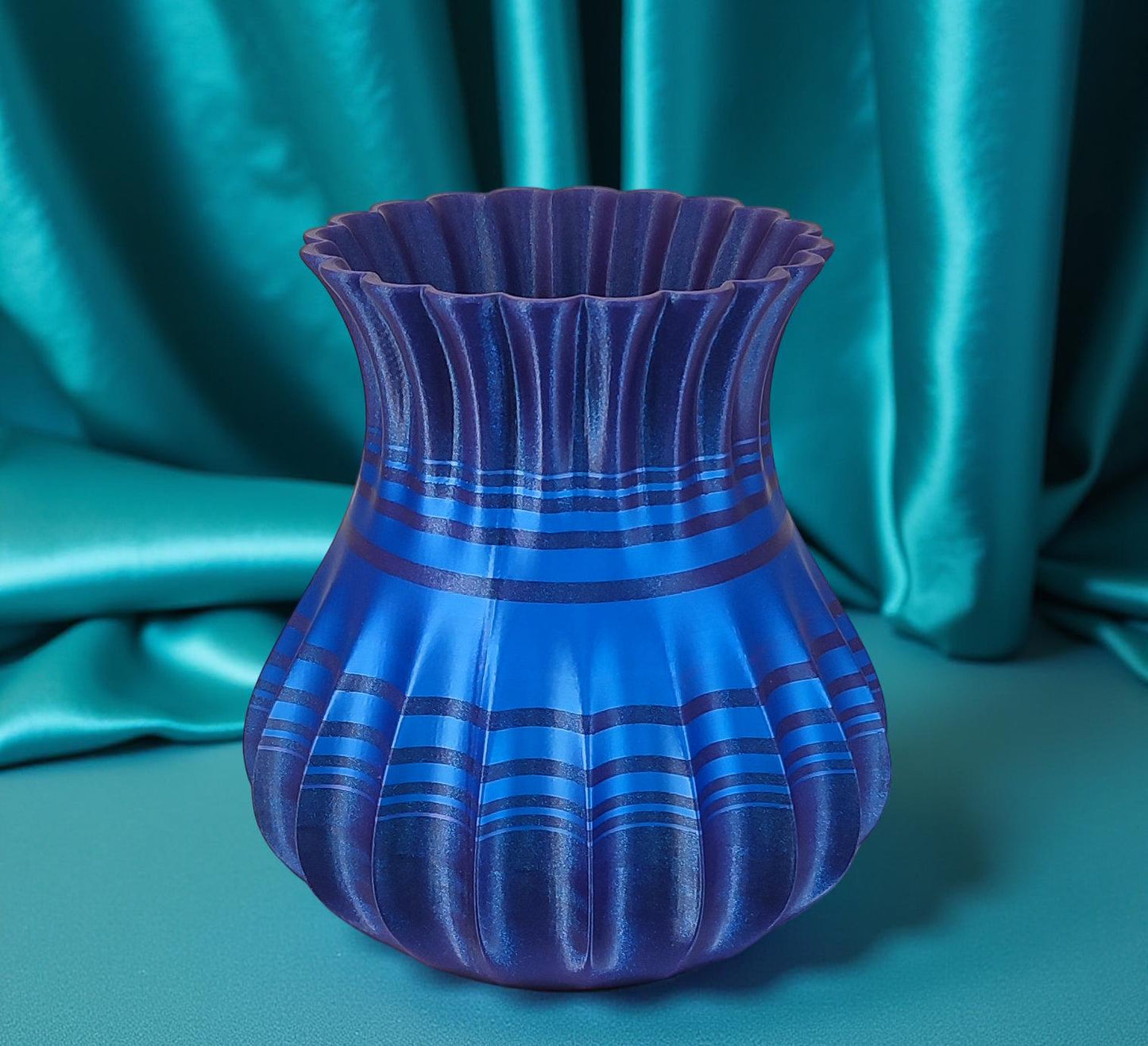 Modern, roomy, whimsical vase with variable color stripes.
