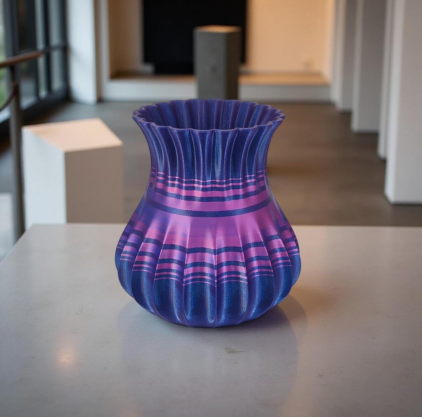 Modern, roomy, whimsical vase with variable color stripes.