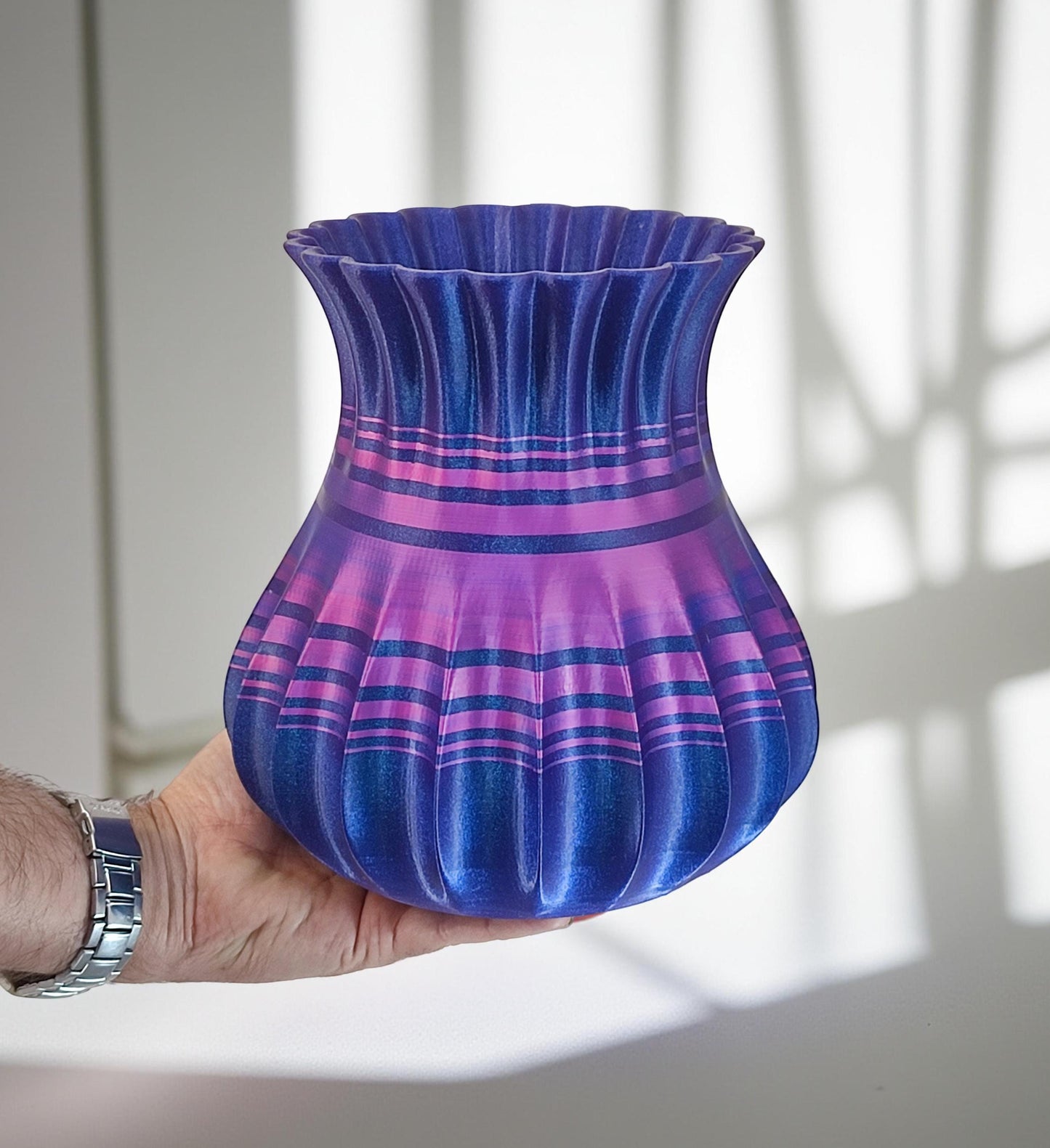 Modern, roomy, whimsical vase with variable color stripes.