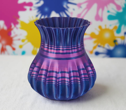 Modern, roomy, whimsical vase with variable color stripes.