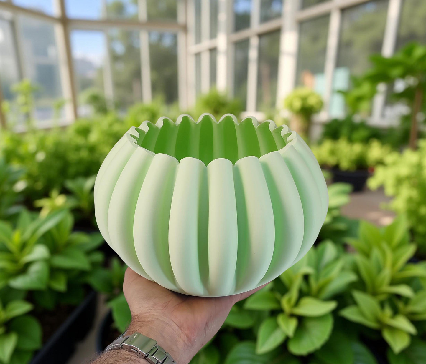 Modern, roomy, pumpkin-shaped vase, light pastel green.