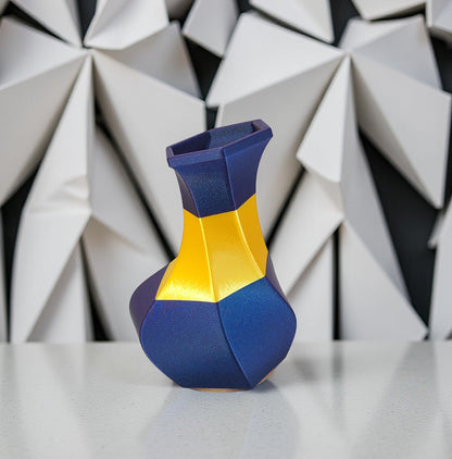 Modern, whimsical vase, glittery blue and golden yellow.