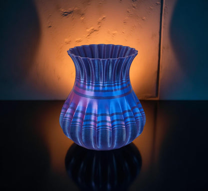 Modern, roomy, whimsical vase with variable color stripes.