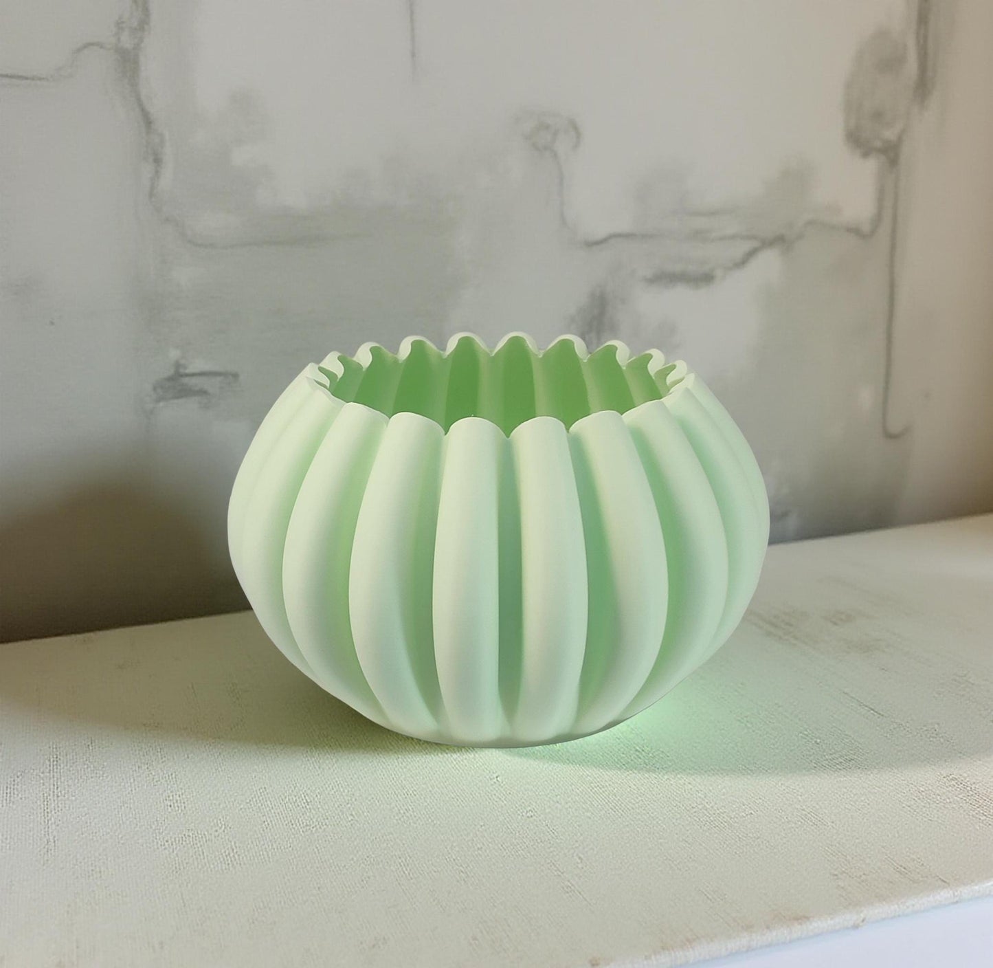 Modern, roomy, pumpkin-shaped vase, light pastel green.