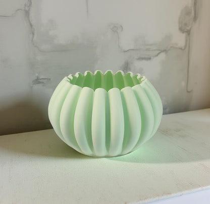 Modern, roomy, pumpkin-shaped vase, light pastel green.