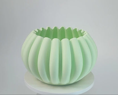 Modern, roomy, pumpkin-shaped vase, light pastel green.