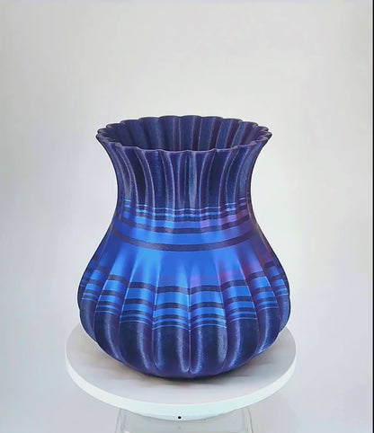 Modern, roomy, whimsical vase with variable color stripes.