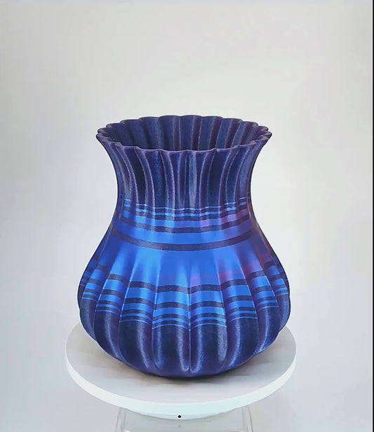 Modern, roomy, whimsical vase with variable color stripes.