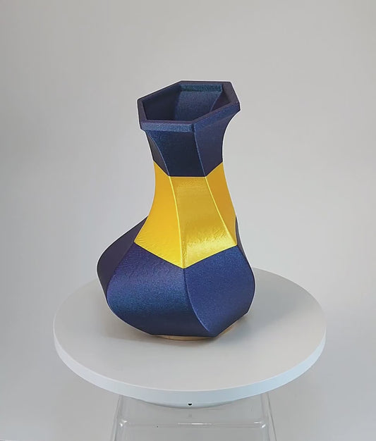 Modern, whimsical vase, glittery blue and golden yellow.